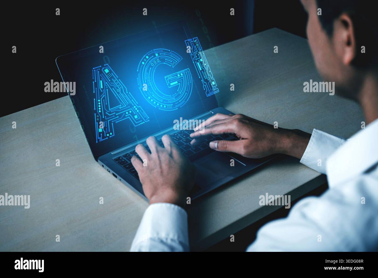 Man Engaged in Technology Work Concept with Laptop Displaying Digital AGI Representation and Futuristic Programmable Elements Haptic. Stock Photo