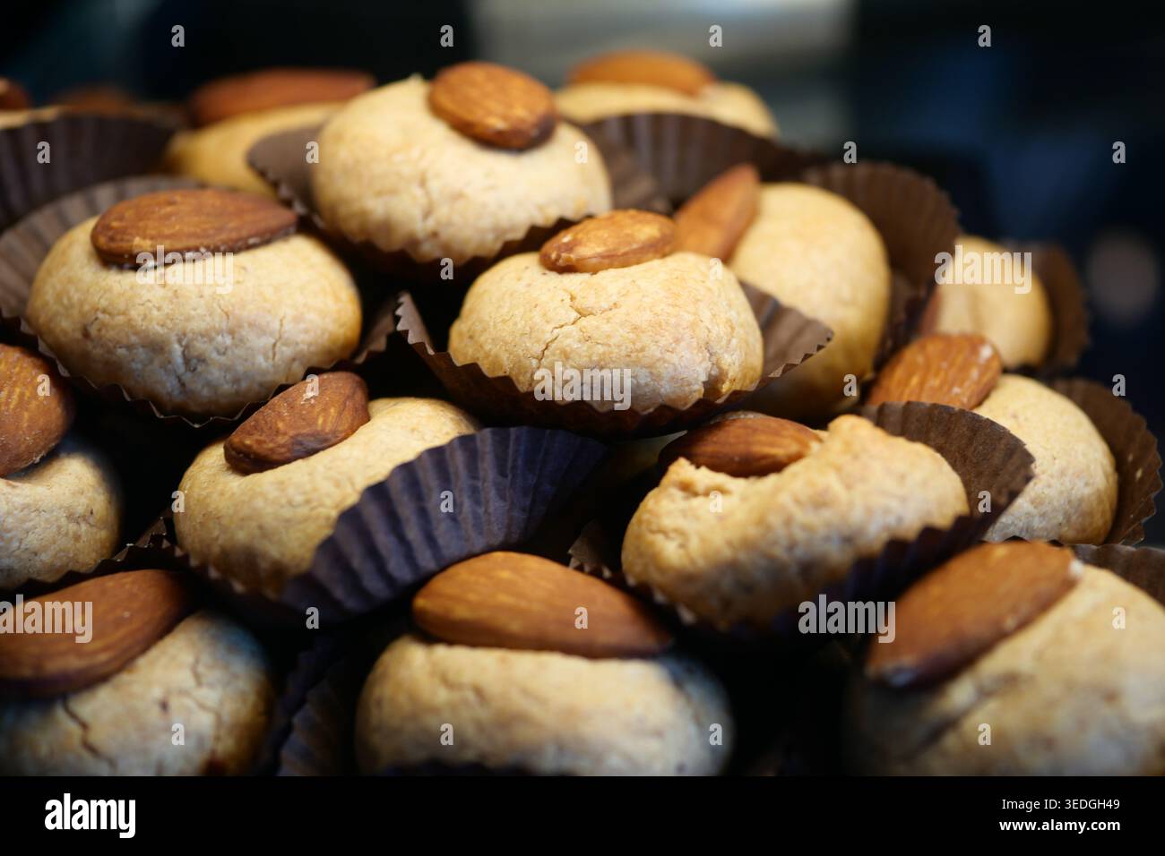 Baking cookies with almonds in a kitchen setting Stock Photo