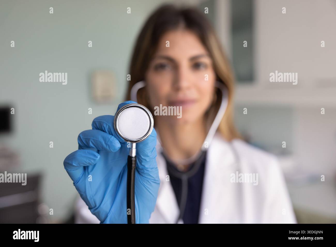 Cardiologist holds stethoscope toward camera, close up Stock Photo