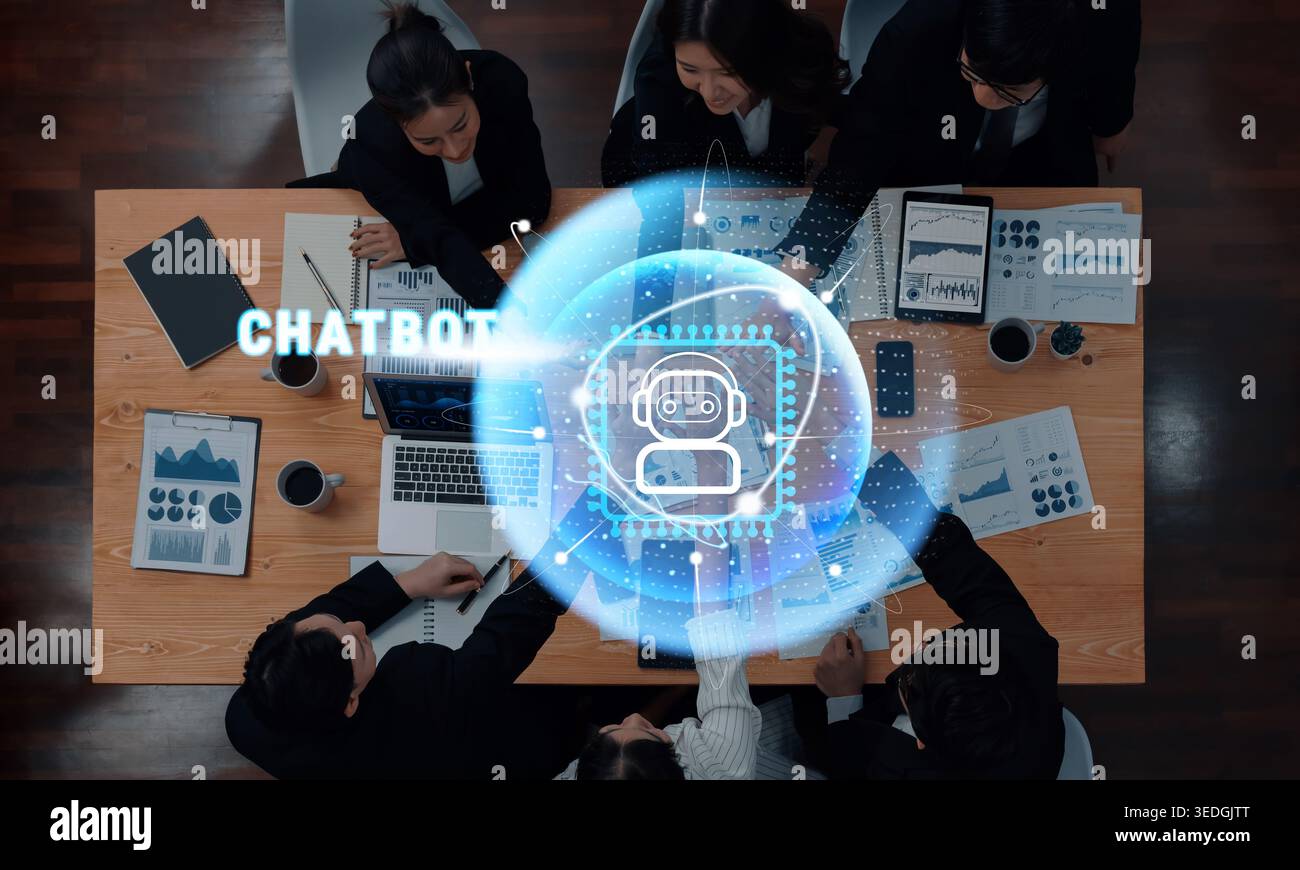 A diverse team of professionals collaborates in a modern office setting, discussing artificial intelligence chatbot tools while analyzing data on Stock Photo