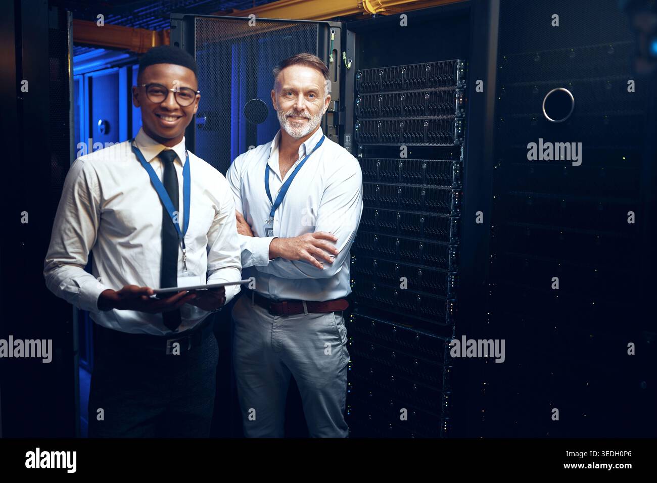 Men, portrait or team with tablet in server room for network security, storage or maintenance. Male people, IT technician or engineer with technology Stock Photo