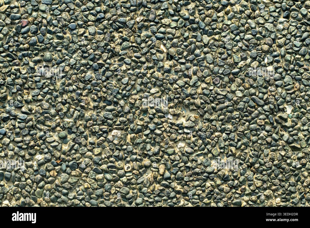 Gray granite surface shows rough, textured patterns Stock Photo