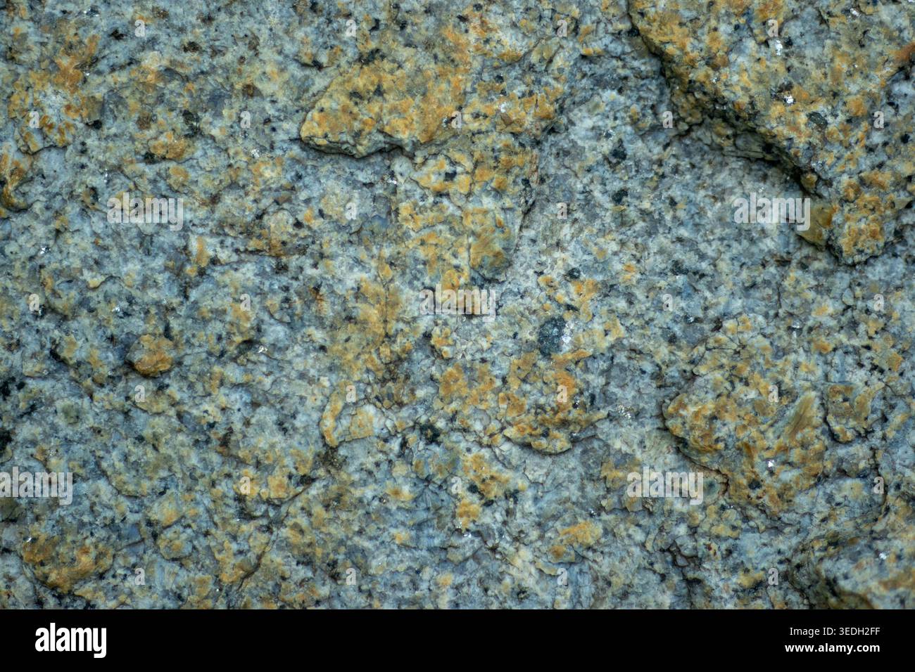 Gray granite surface shows rough, textured patterns Stock Photo