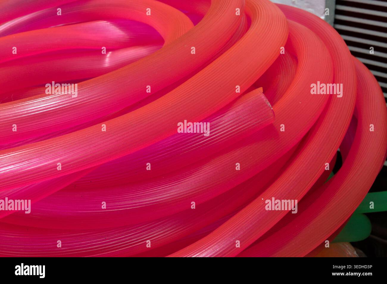 many long pink red plastic pipe for building Stock Photo