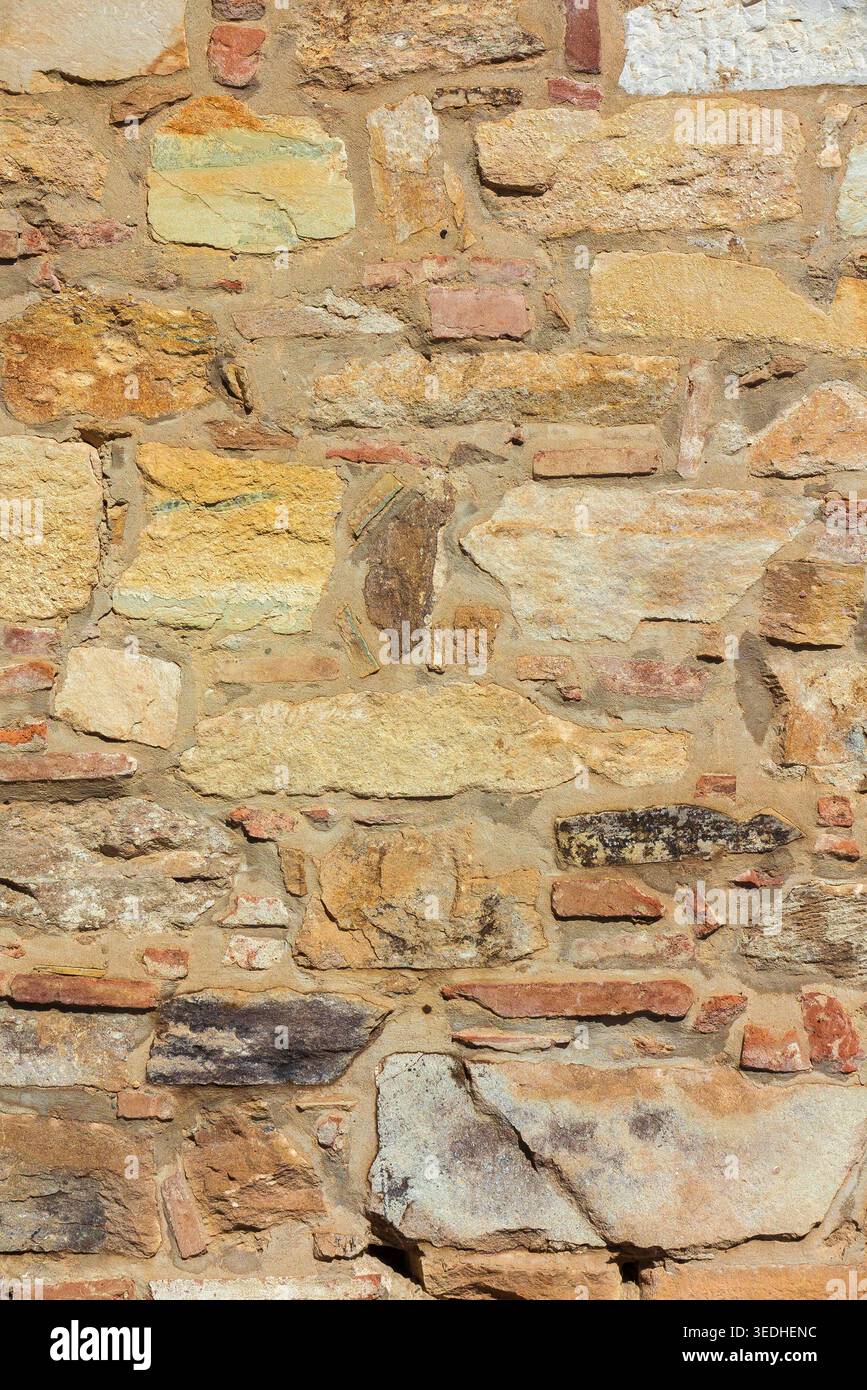 Ancient composite stone wall with bricks as background Stock Photo