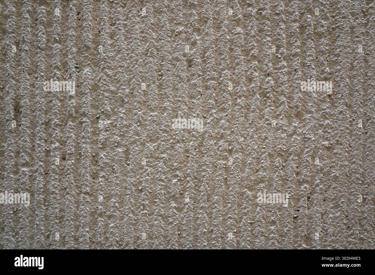 Beige ridged plaster wall texture with vertical grooved pattern in Clermont-Ferrand Stock Photo