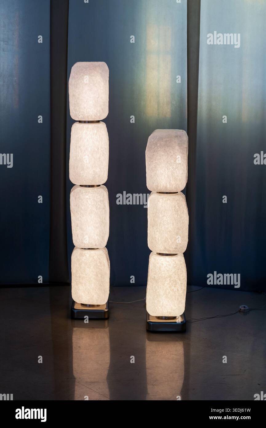 Two modern standing lamps featuring stacked translucent modules creating artistic illumination Stock Photo