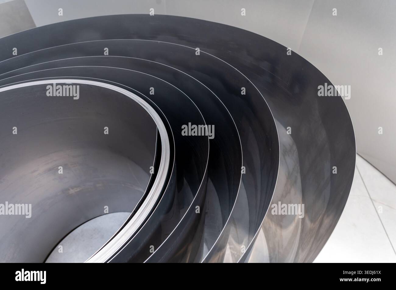 Stainless steel sheets forming abstract curved industrial pattern Stock Photo