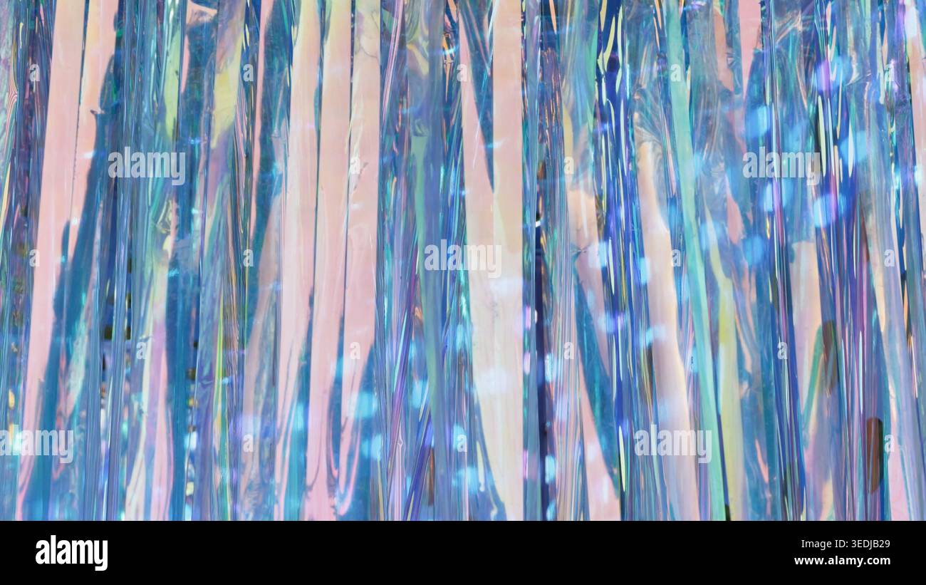 Iridescent tinsel stream creating an abstract shimmering light background Stock Photo