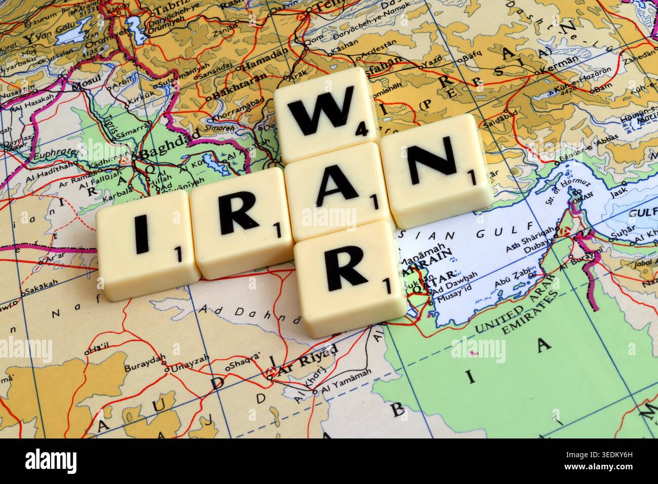 Scrabble tiles spelling Iran and war on a Middle East map, a concept image for oil price shocks, inflation and geopolitical risk. Stock Photo