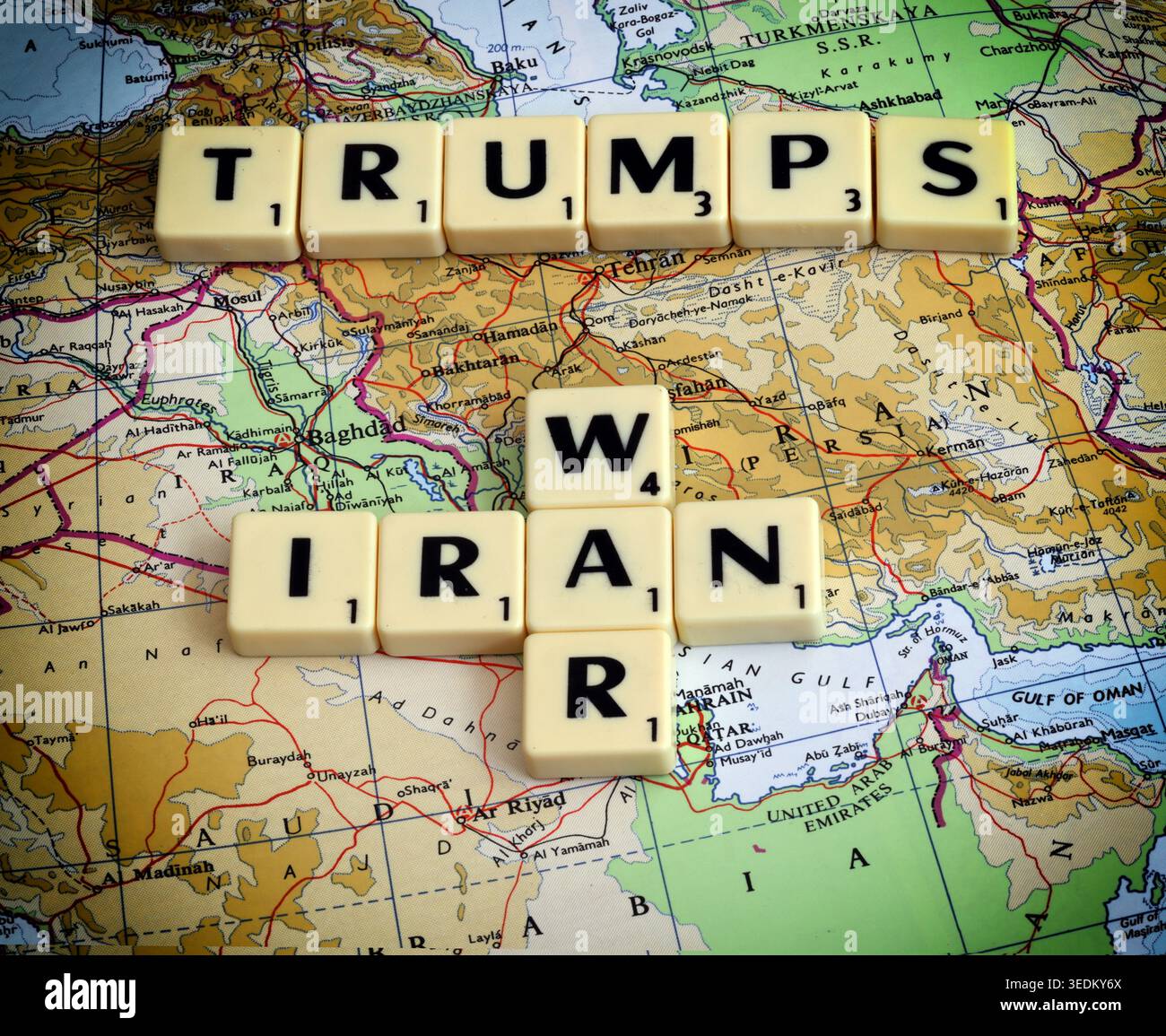 Scrabble tiles spelling Trump, Iran and war on a Middle East map, illustrating US foreign policy and conflict risk. Stock Photo