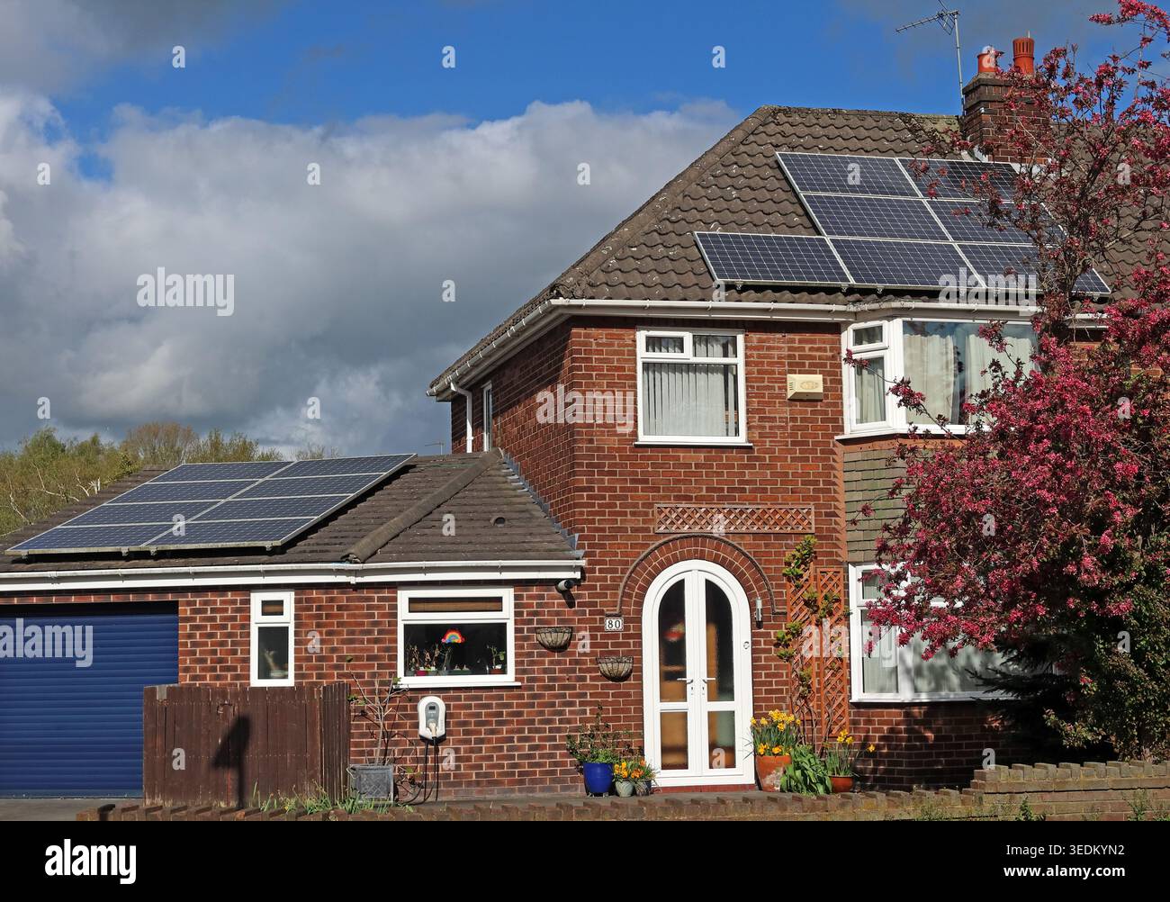Twin solar PV arrays on a house in Thelwall, Warrington, Cheshire, England, UK. Stock Photo