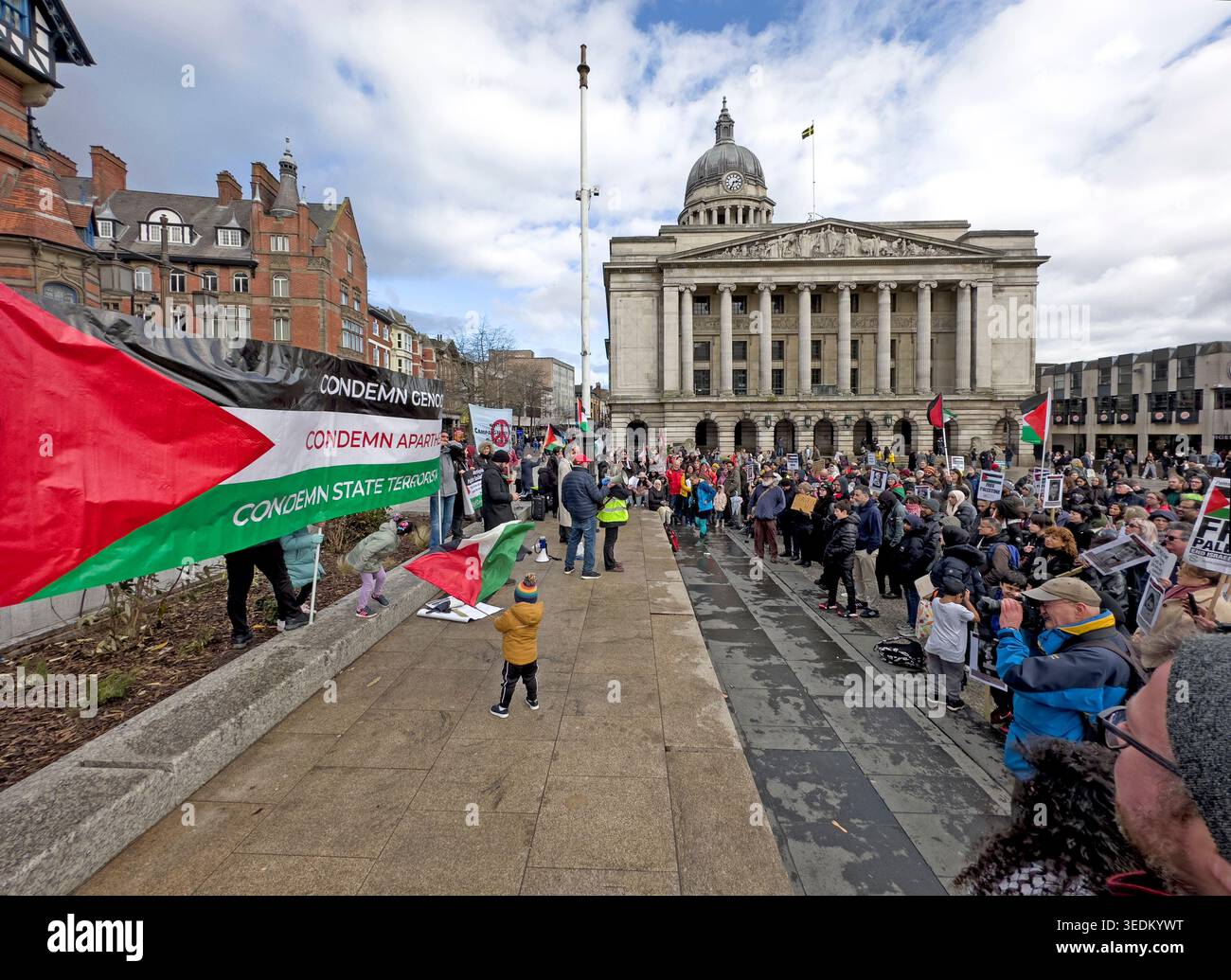 Peaceful Palestine protest in Nottingham’s Old Market Square, with flags, placards and crowd outside the Council House. Stock Photo