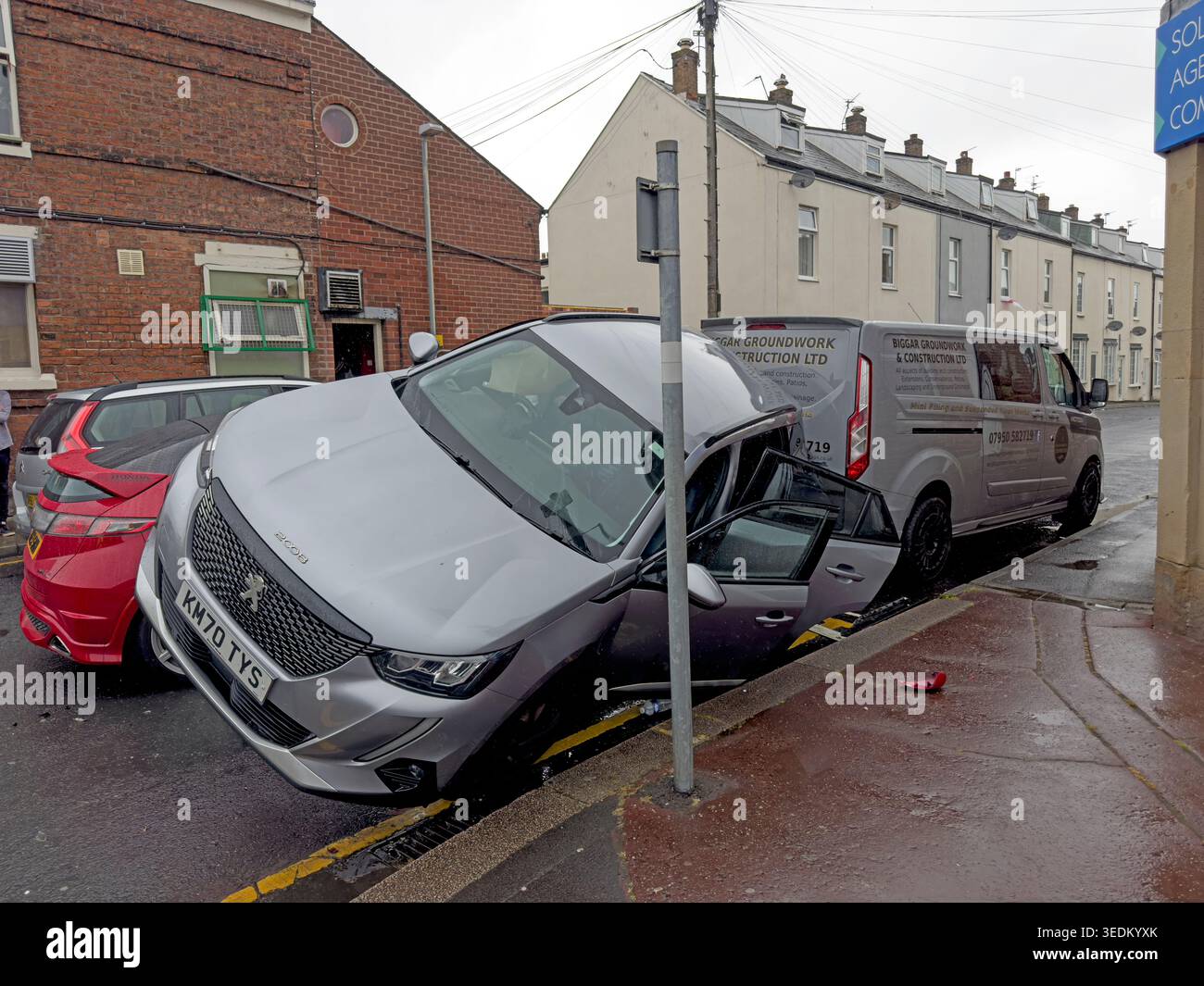Two cars damaged in a road traffic collision on Hough Lane, Leyland, with one vehicle mounted partly over the other Stock Photo