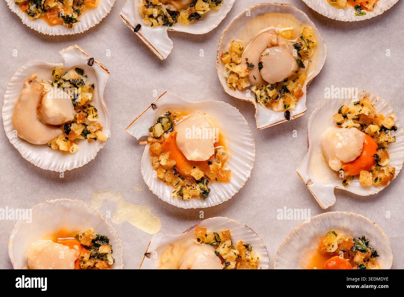 Cooked scallops with sauce on a baking sheet Stock Photo