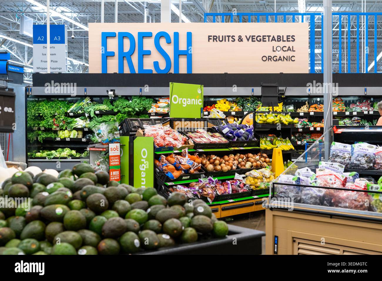 Walmart Supercenter Produce Department Featuring Fresh Avocados Fruits And Vegetables With Vibrant Signage Stock Photo