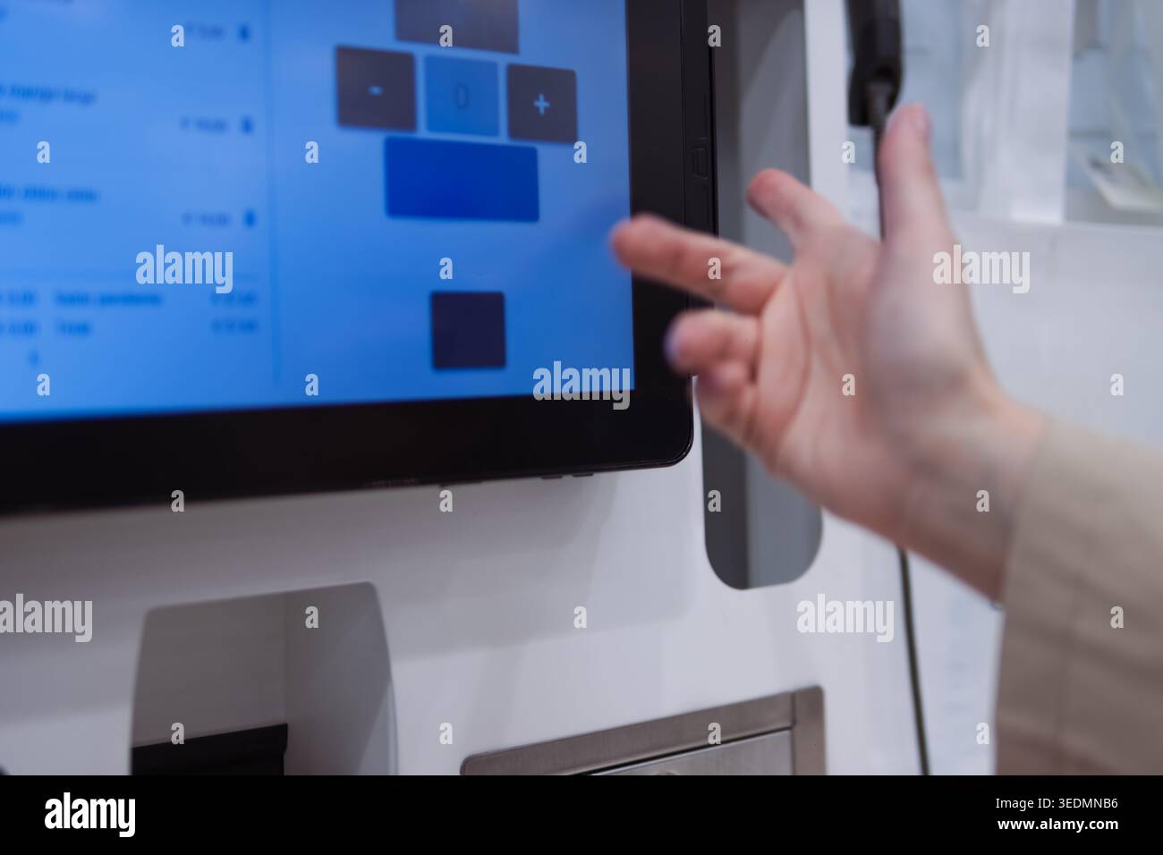 Hand interacting with a self-service interactive digital touchscreen kiosk. Selecting options for ordering or payment. Using modern technology for eff Stock Photo