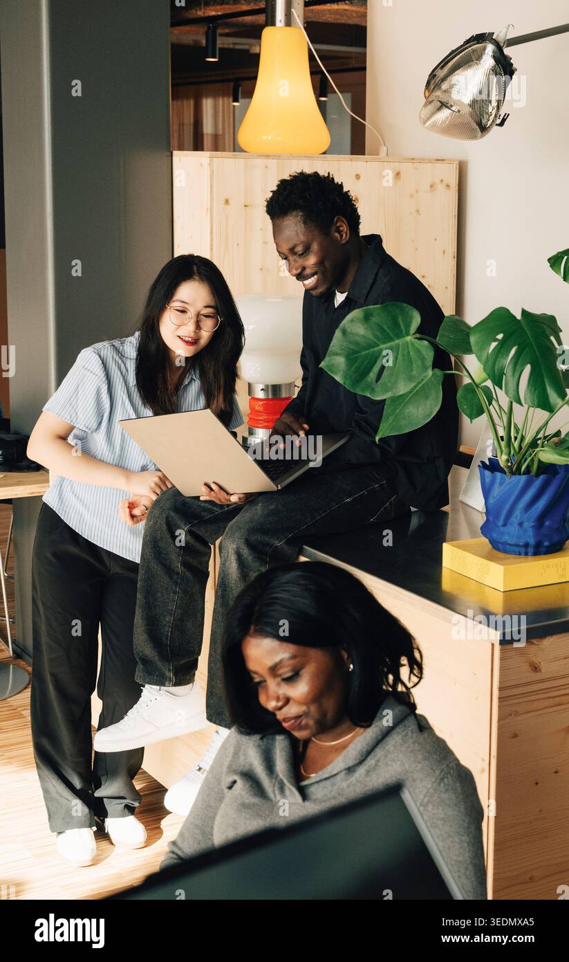Group of diverse computer programmers working on laptop at office Stock Photo