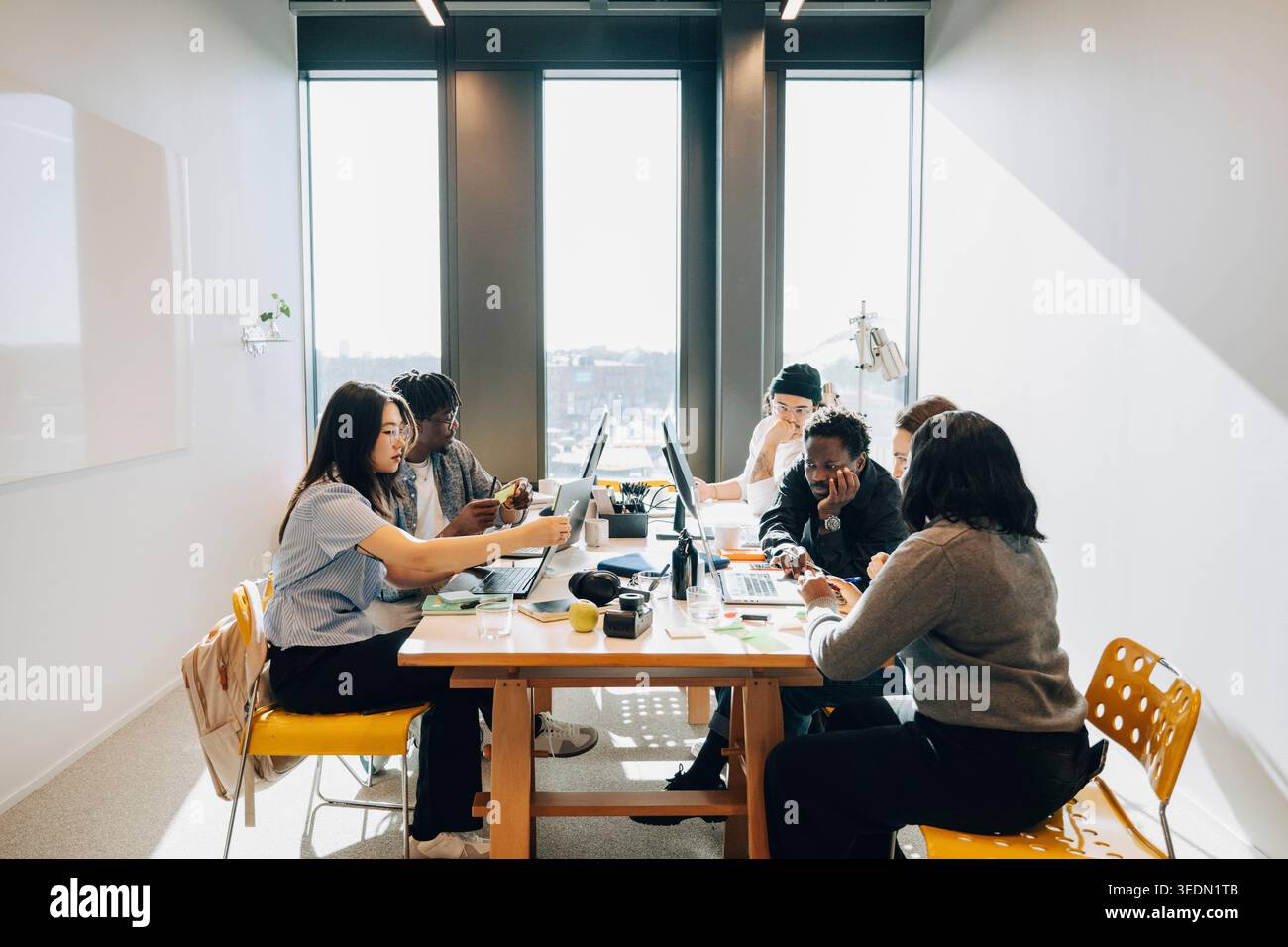 Group of diverse entrepreneurs working on project at their creative workspace Stock Photo