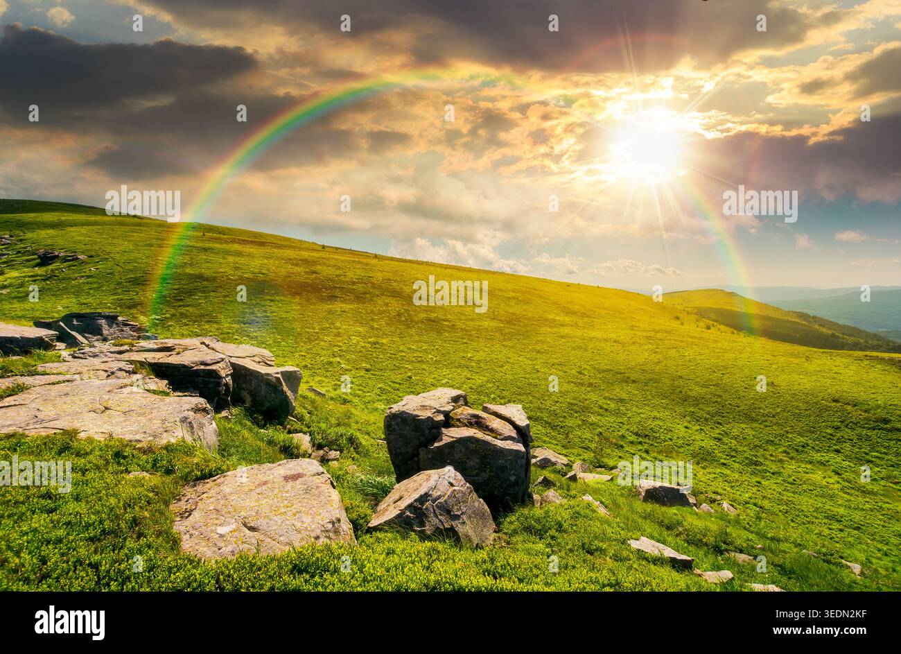 sunset over mountain landscape with alpine meadow in dappled light. carpathian mountain scenery in summer. view in to the distant valley landscape. ro Stock Photo