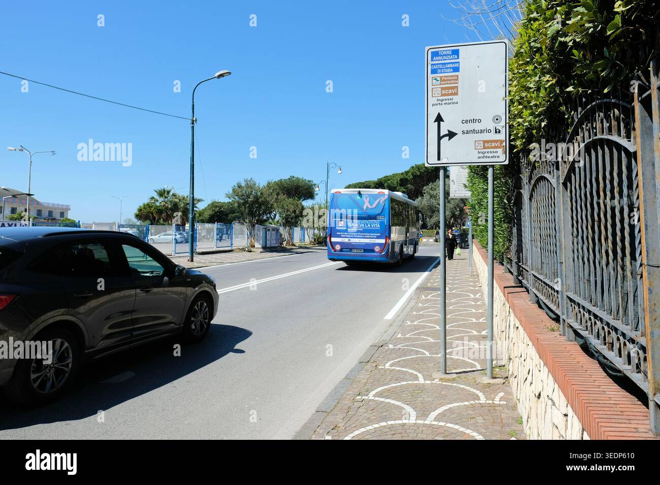 Traffic sign on Via Plinio in Pompei, Italy towards downtown, excavation site, chapel and the towns of Torre Annunziata and Castellamare di Stabia. Stock Photo