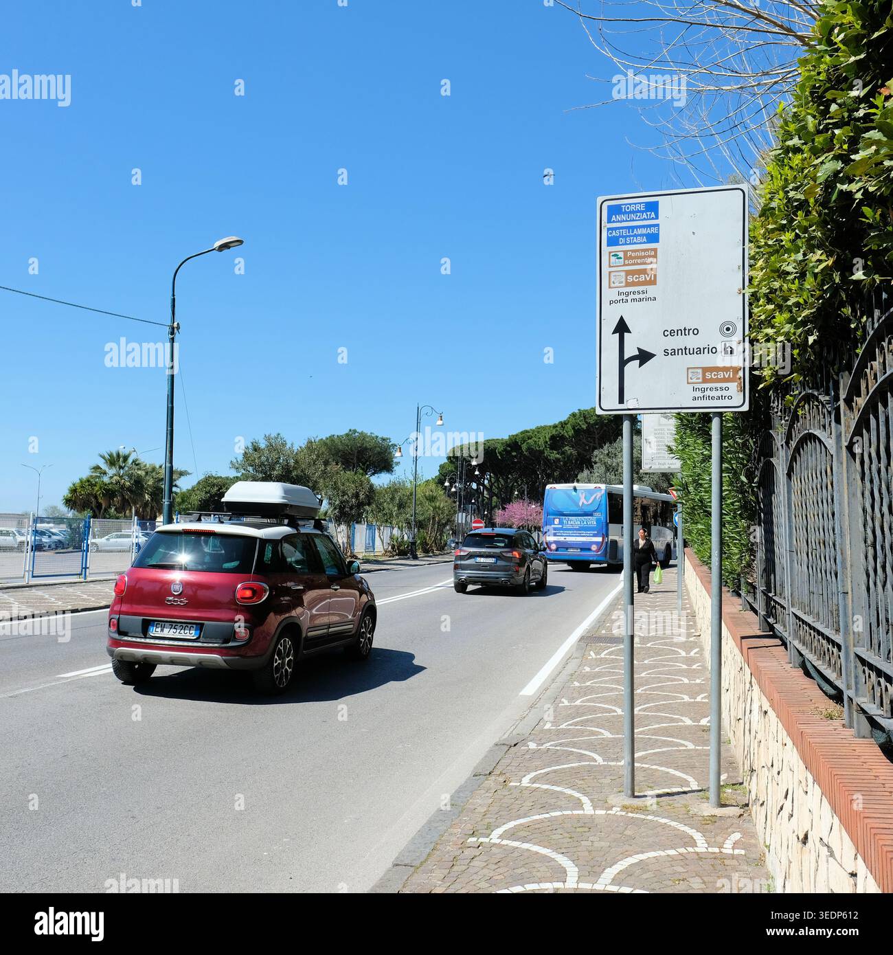 Traffic sign on Via Plinio in Pompei, Italy towards downtown, excavation site, chapel and the towns of Torre Annunziata and Castellamare di Stabia. Stock Photo