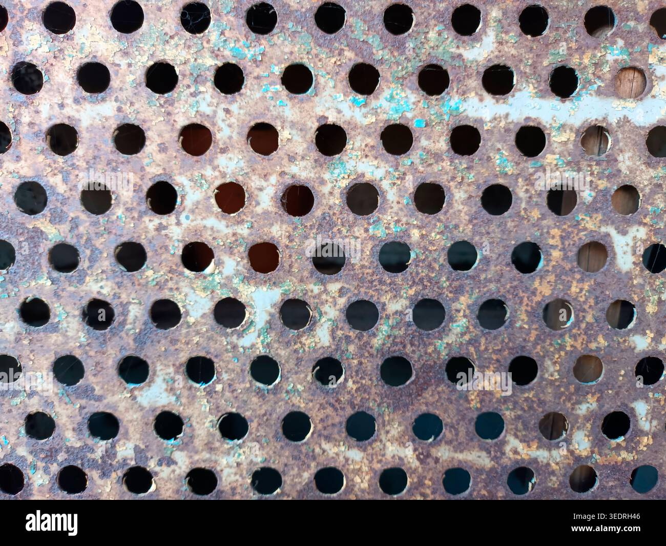 Rusty perforated plate as background or texture Stock Photo