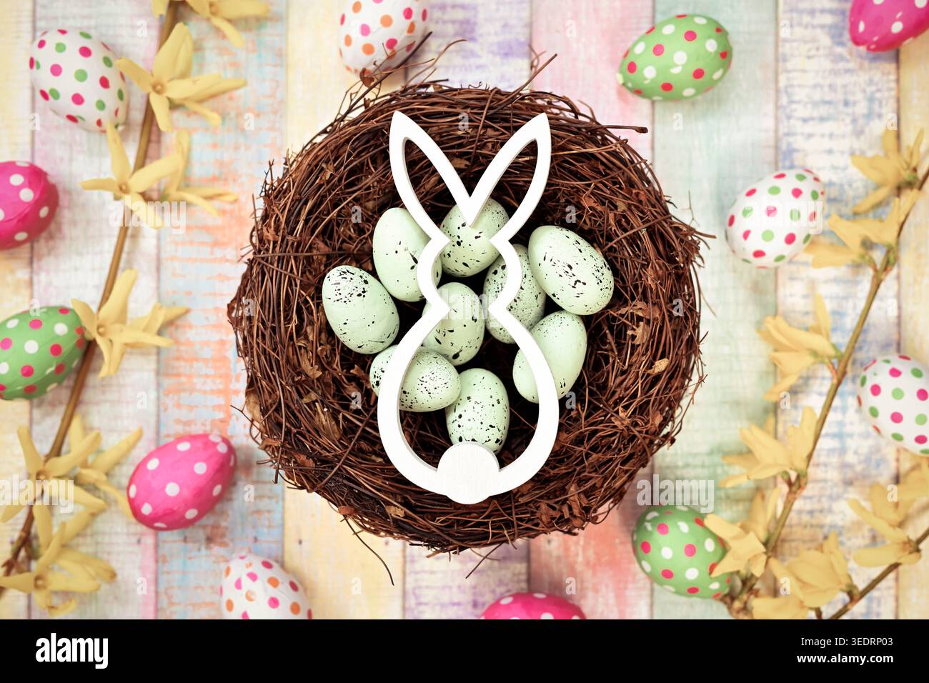 Easter bunny in an Easter nest with Easter eggs Stock Photo