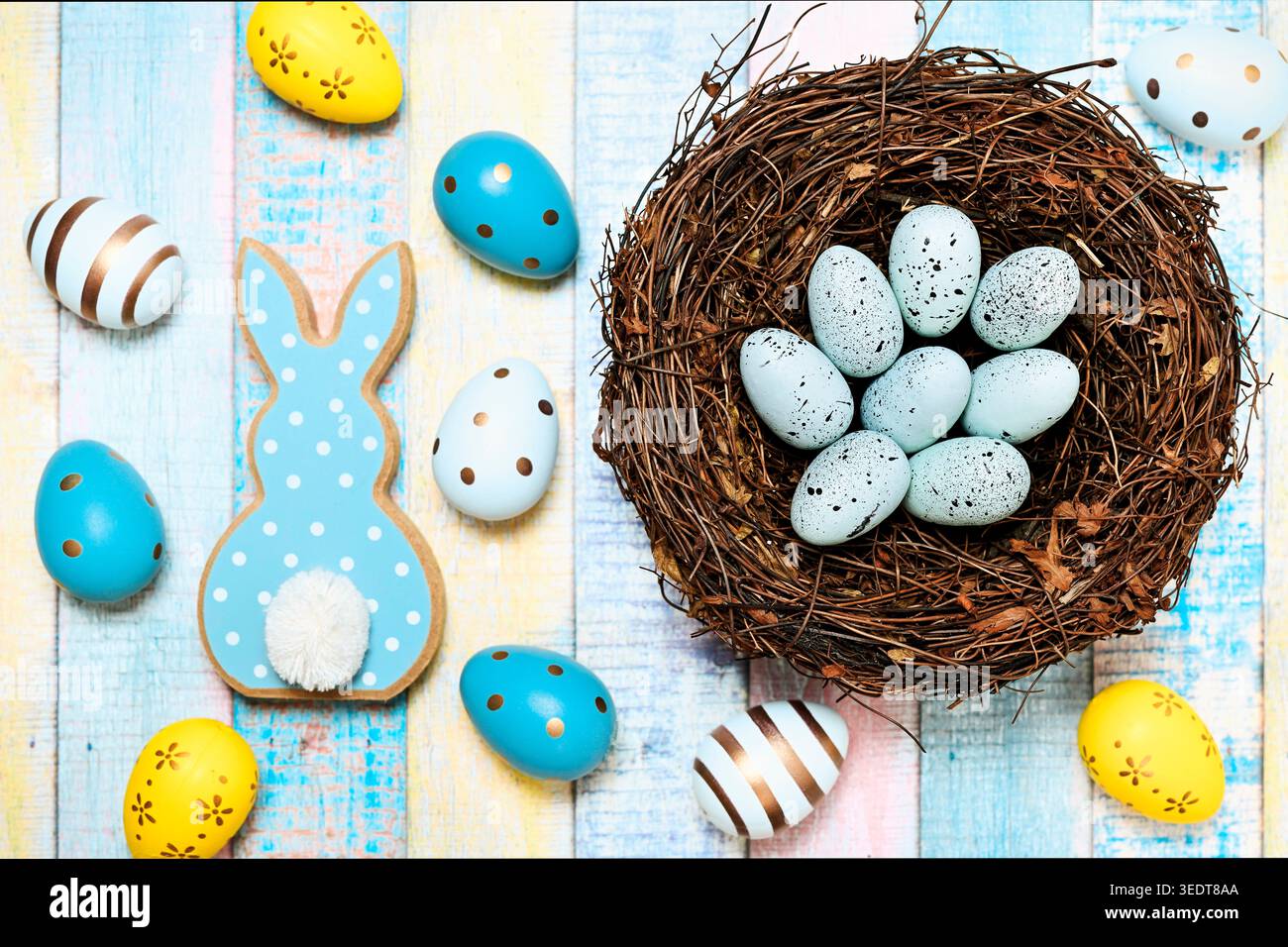 Easter bunny figurine with Easter eggs and Easter nest Stock Photo