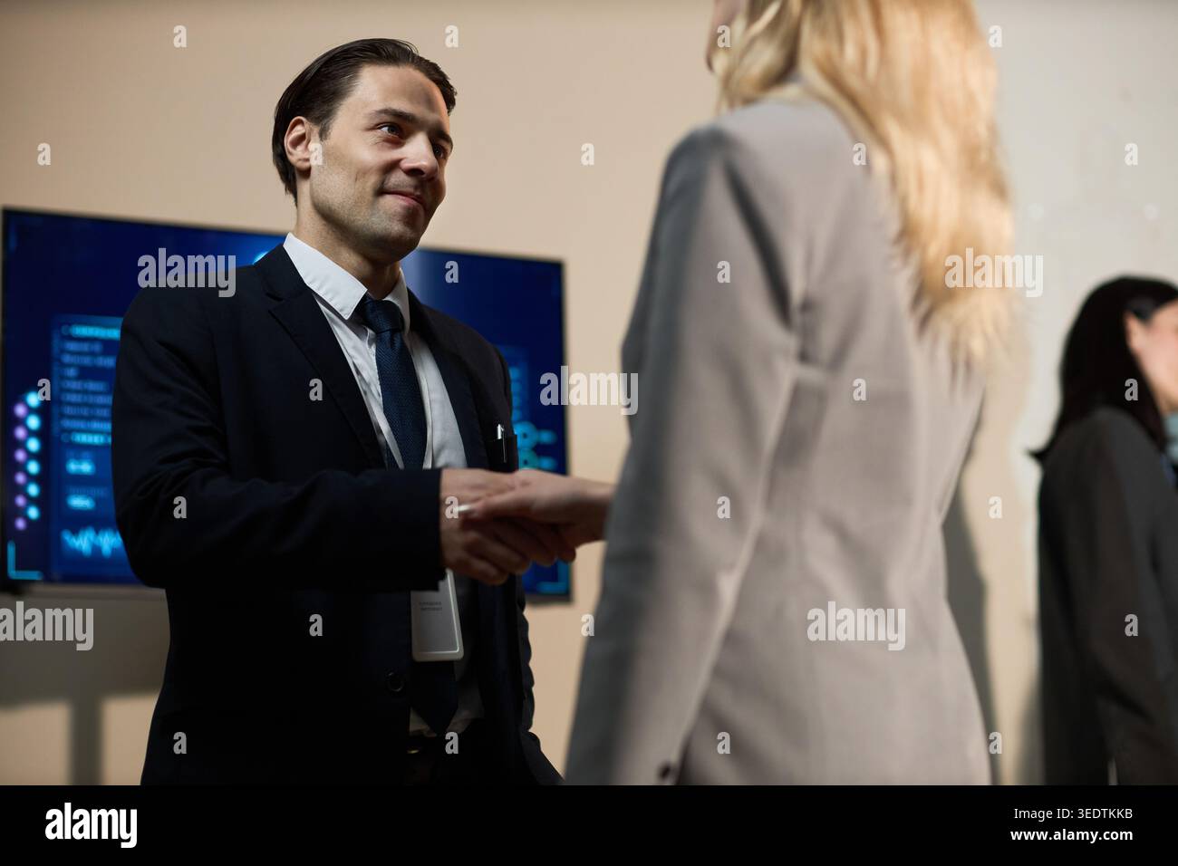 Businessman Shaking Hands during Corporate Networking Event Stock Photo