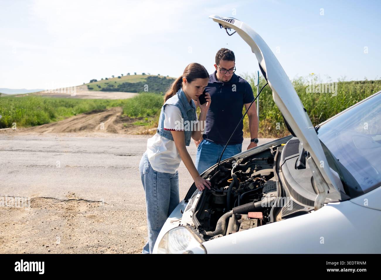 Young couple experiencing car breakdown on roadside Stock Photo