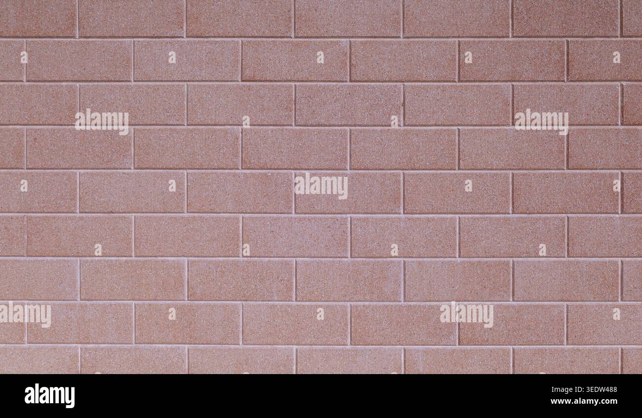 Pink sandblasted brick wall. Full frame, background and texture. Stock Photo