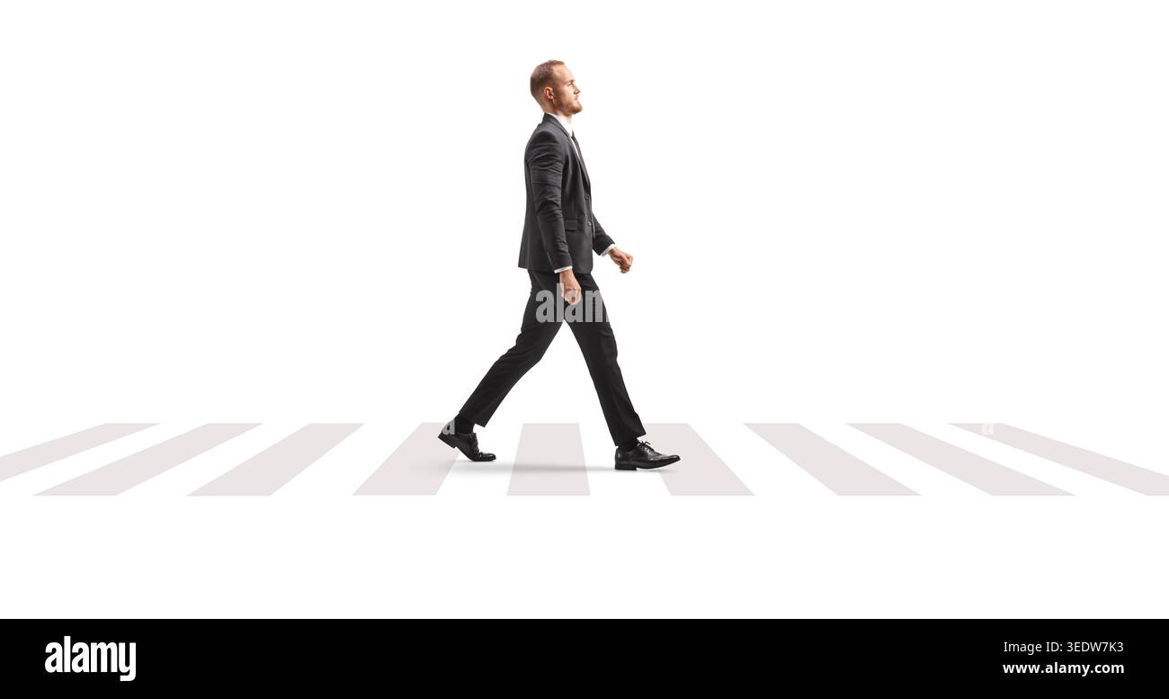 Full length profile shot of a businessman walking at zebra crossing isolated on white background Stock Photo