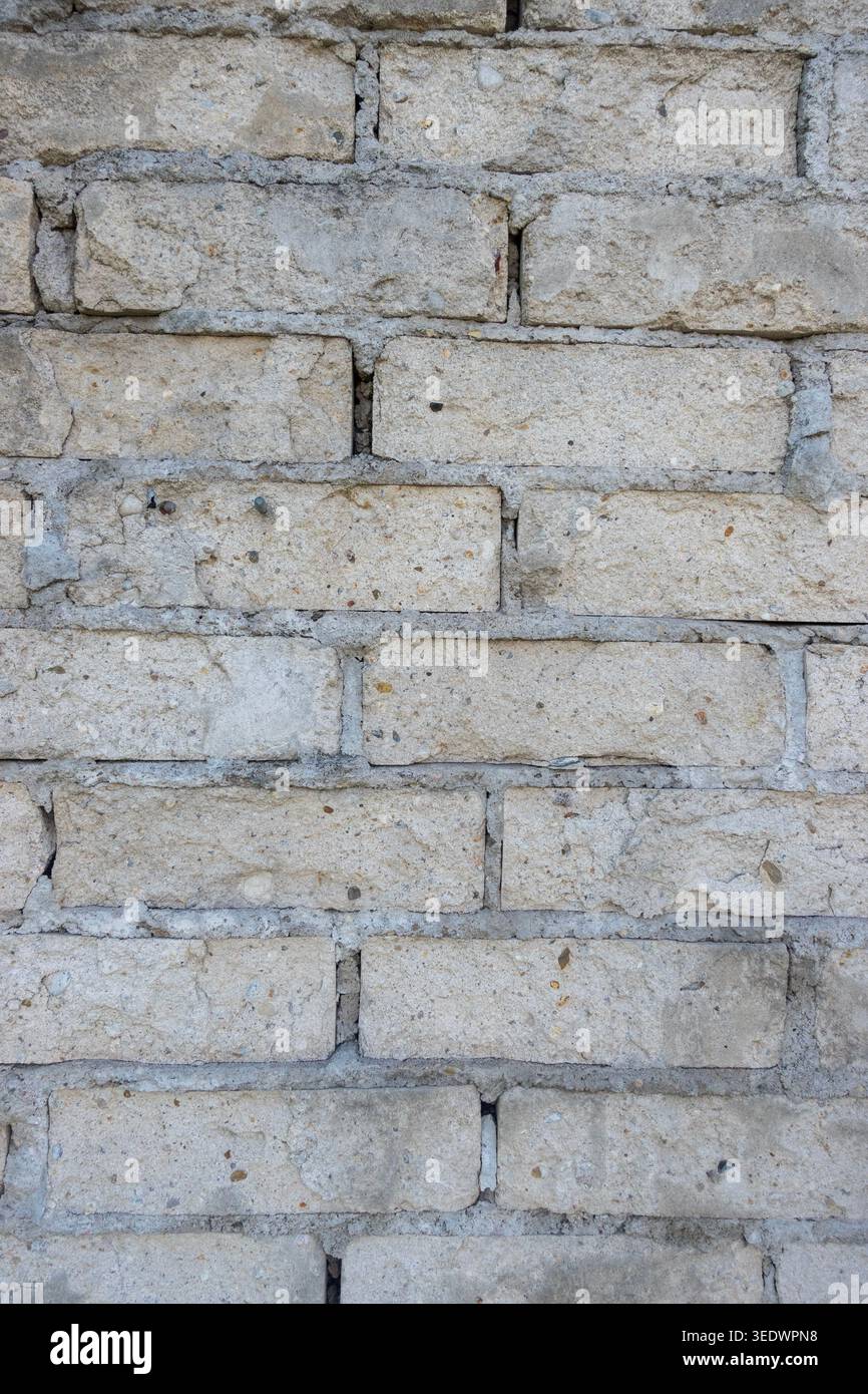 Old light brick wall texture with weathered masonry pattern background and rustic construction detail Stock Photo