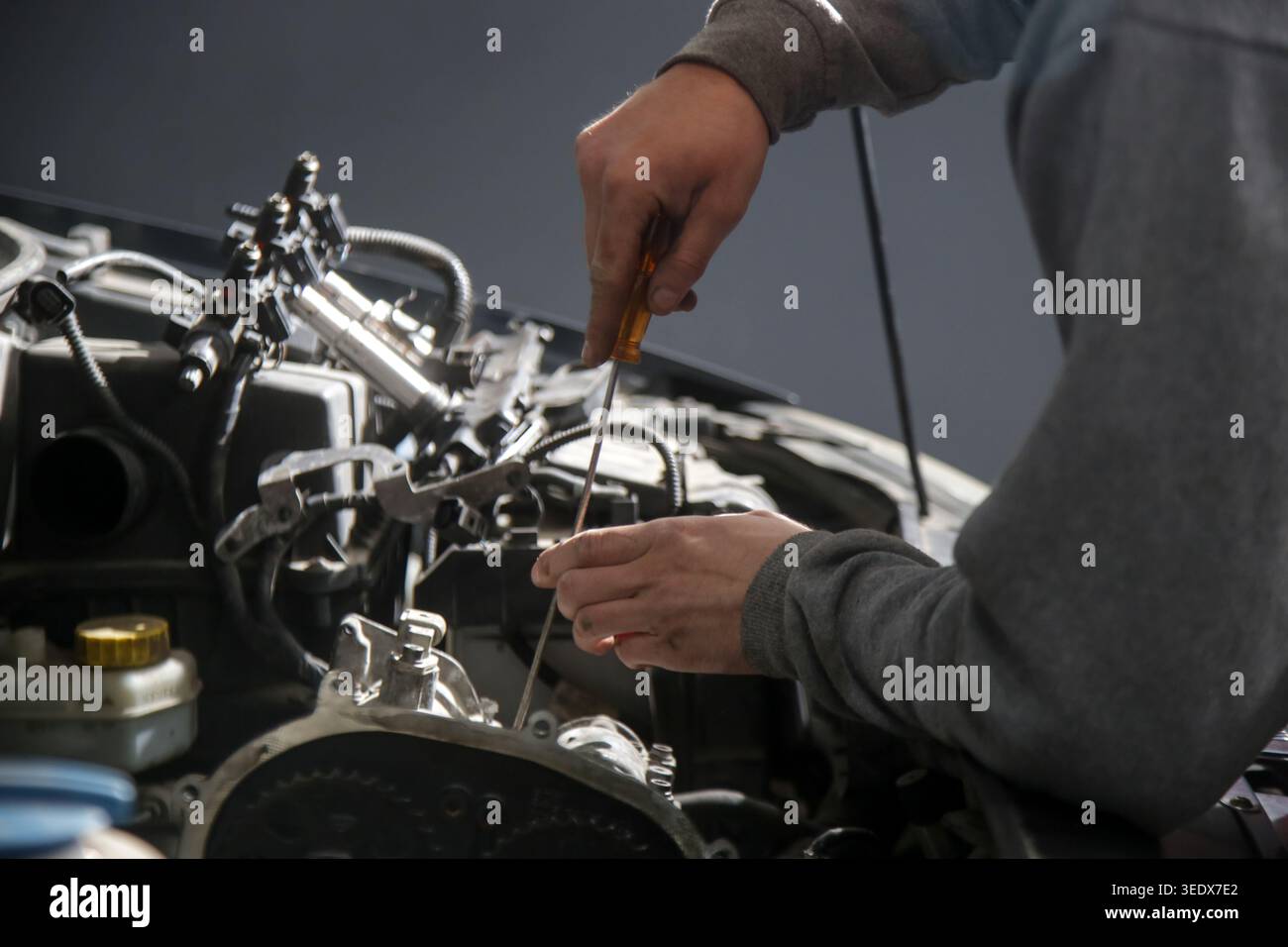 Car Maintenance - Mechanic Checking Engine Oil Level Using Dipstick at ...