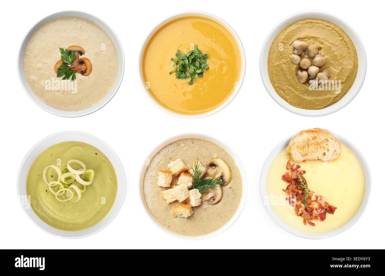 Different tasty soups in bowls isolated on white, collage. Top view Stock Photo