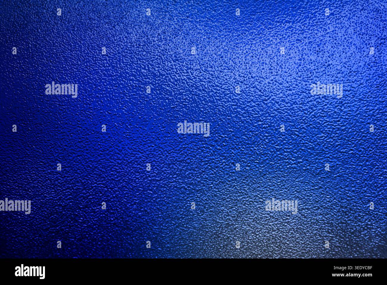 Vibrant royal blue bumpy textured surface with subtle gradient lighting Stock Photo