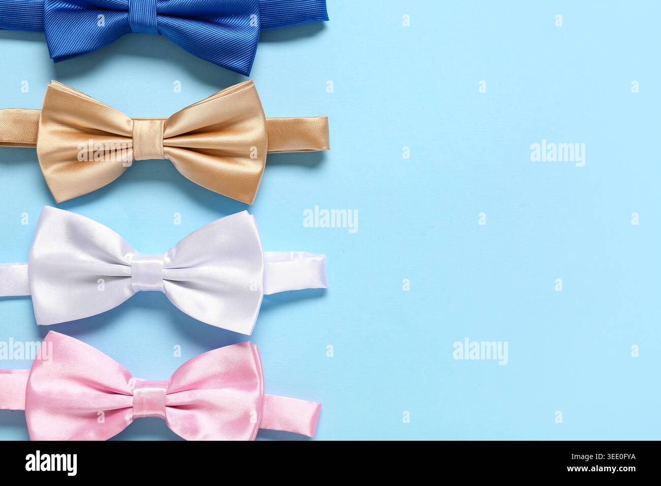 Different stylish bow ties on blue background Stock Photo