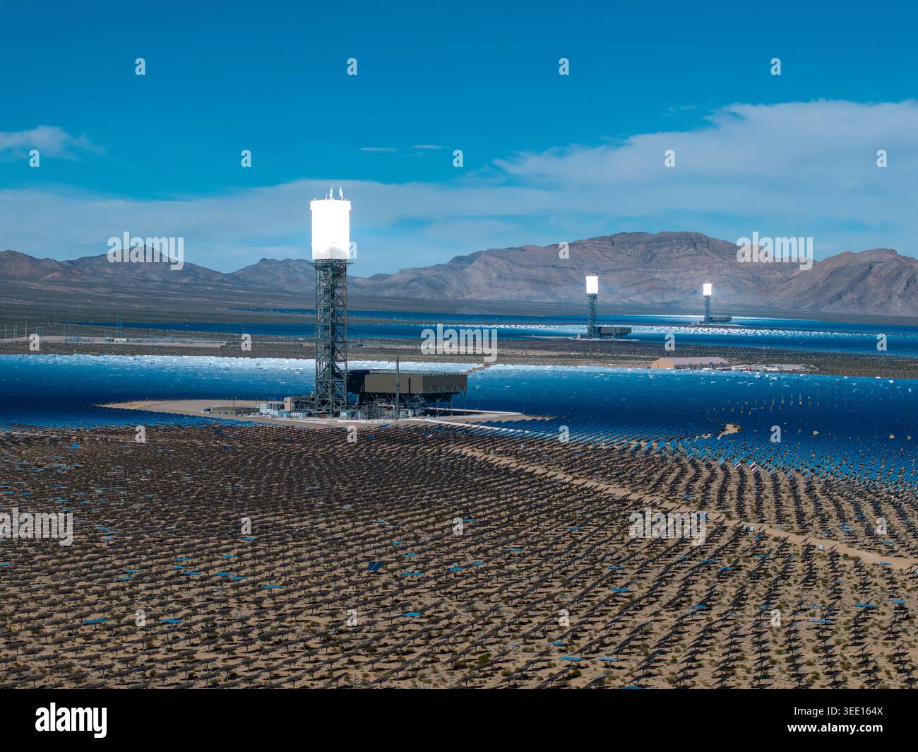 Elevated view of concentrated solar power towers and expansive mirror ...