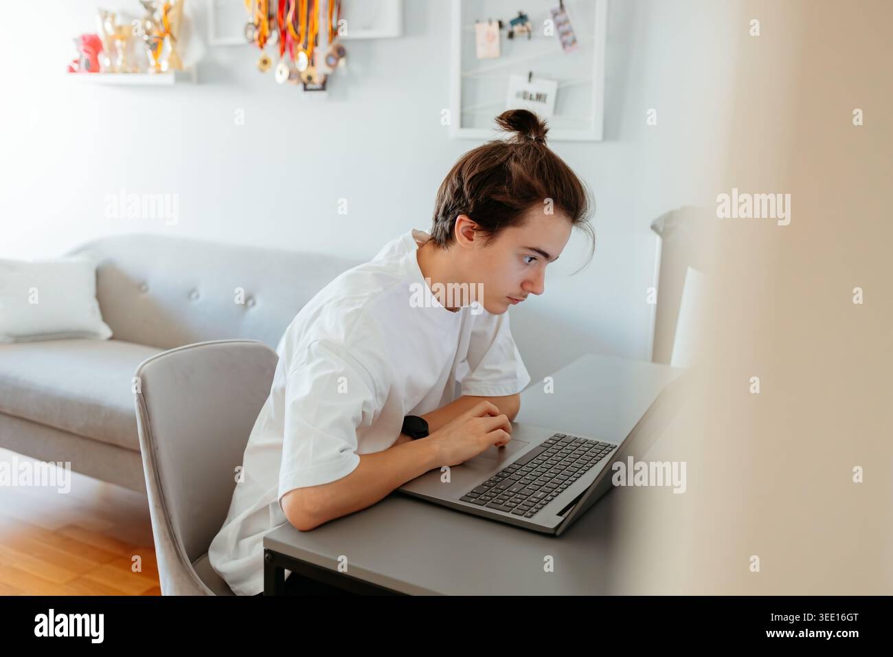Focused person working on laptop in modern home office Stock Photo