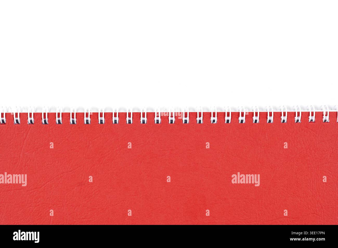 Red notebook cover with spiral binding on white background with copy space Stock Photo
