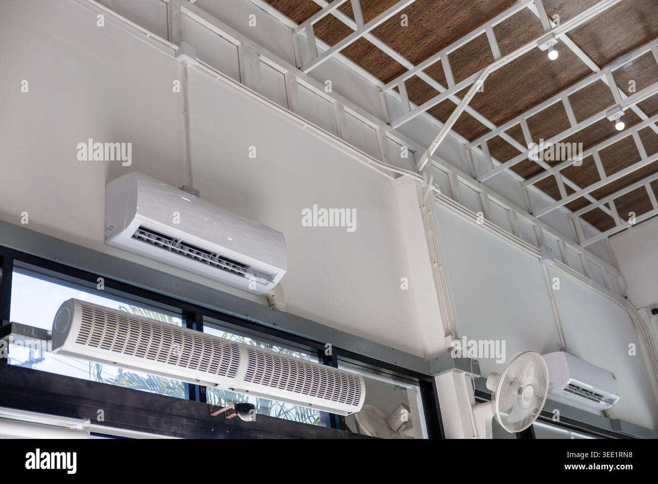 Modern white interior wall featuring mounted air conditioner unit for ...