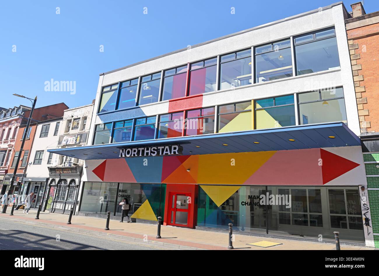 Northstar offices at 135-141 Oldham Street, Manchester, with colourful geometric frontage beneath a bright blue summer sky Stock Photo