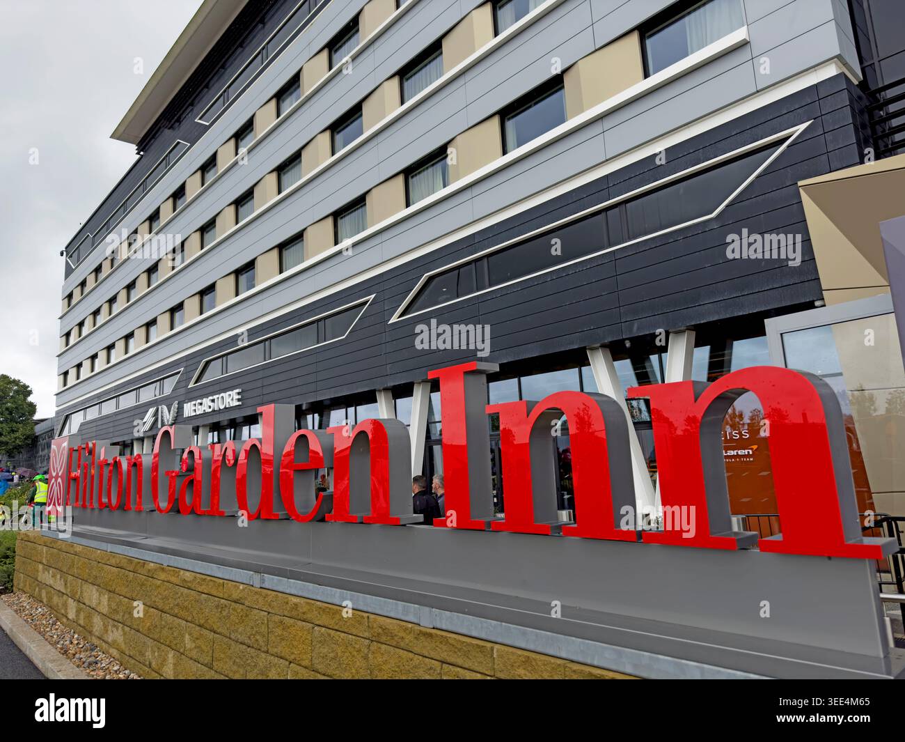 Large Hilton Garden Inn sign outside Silverstone's circuit hotel, a base for high-priced British Grand Prix hospitality, with views of the Hamilton st Stock Photo