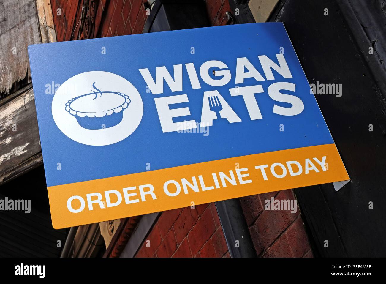 Labour eats humble pie in local elections as ReformUK sweep seats - Wigan Eats sign for a local takeaway ordering app in Wigan, with a pie logo Stock Photo