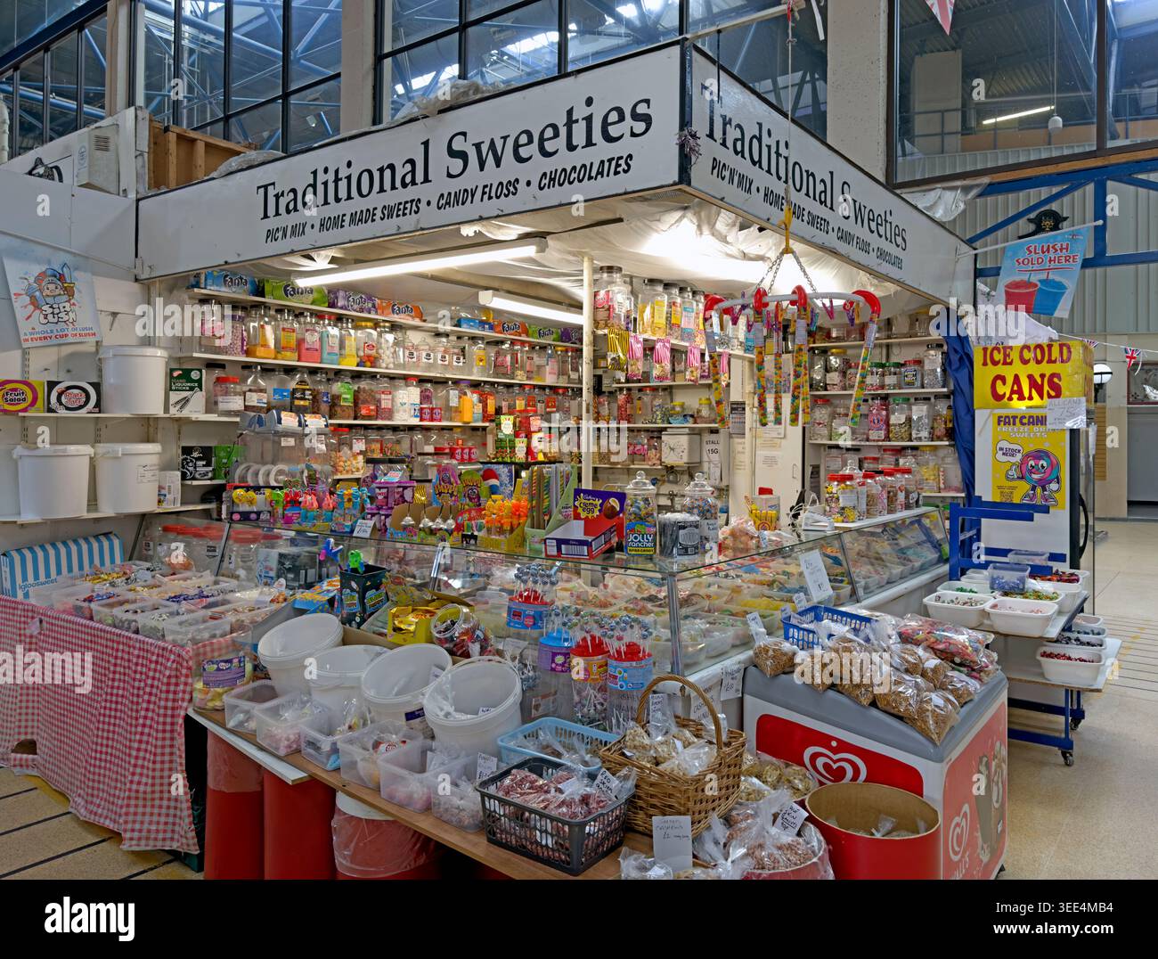 Old fashioned sweet shop stall at Wigan indoor market, packed with retro sweets, candy floss, chocolates and pick and mix treats. Stock Photo