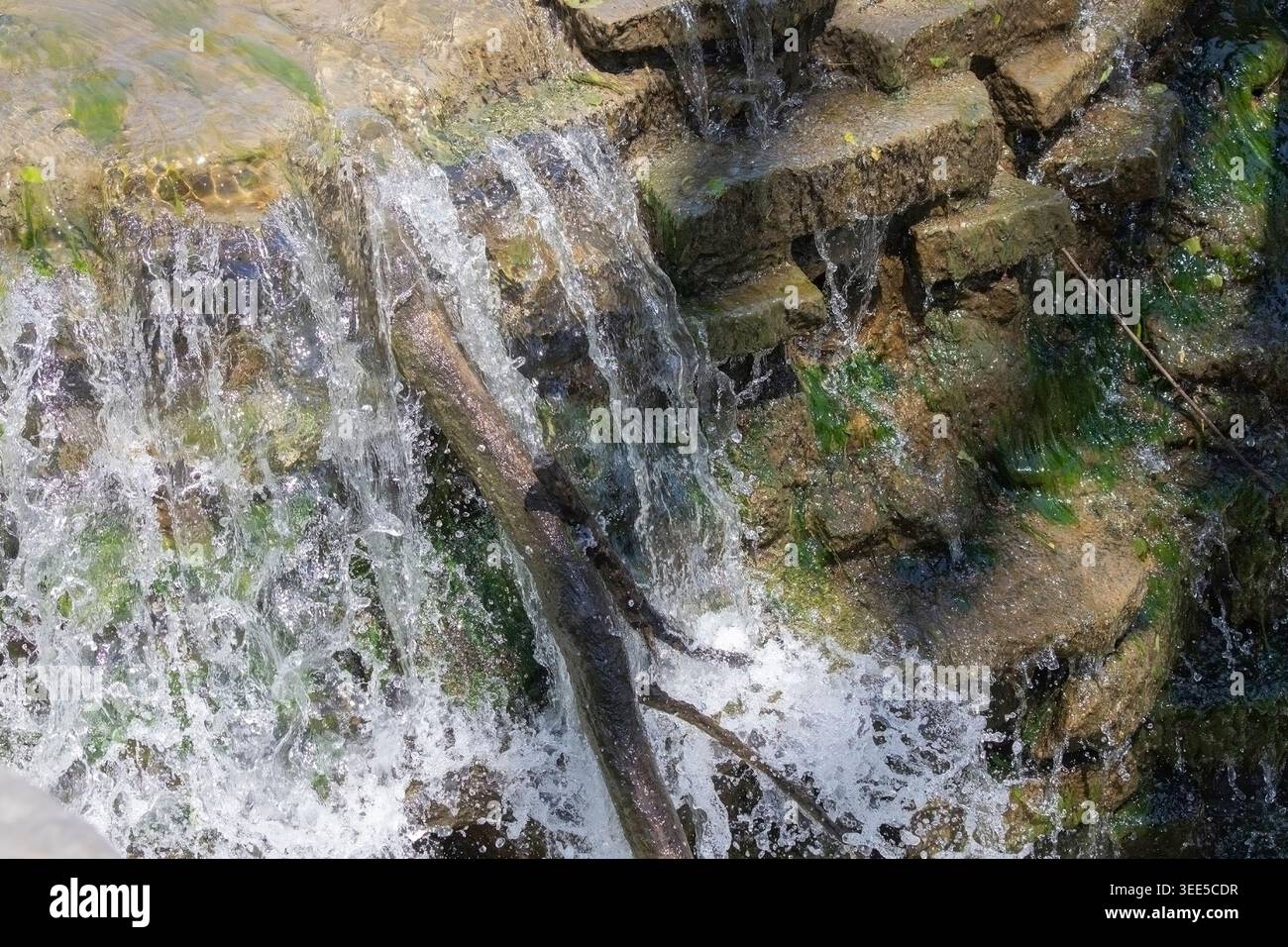 Artificial small waterfall in the park Stock Photo