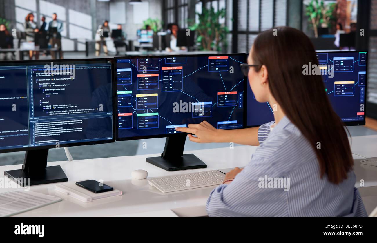 Woman Focused On Visual Programming Using Node-based No Code Software. Stock Photo