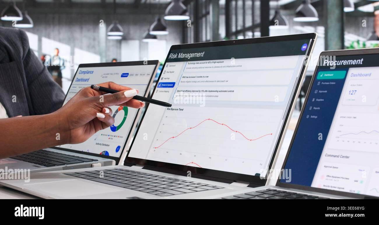 Enterprise Risk Managers Collaborate On Strategic Data Analysis Using Laptop. Stock Photo