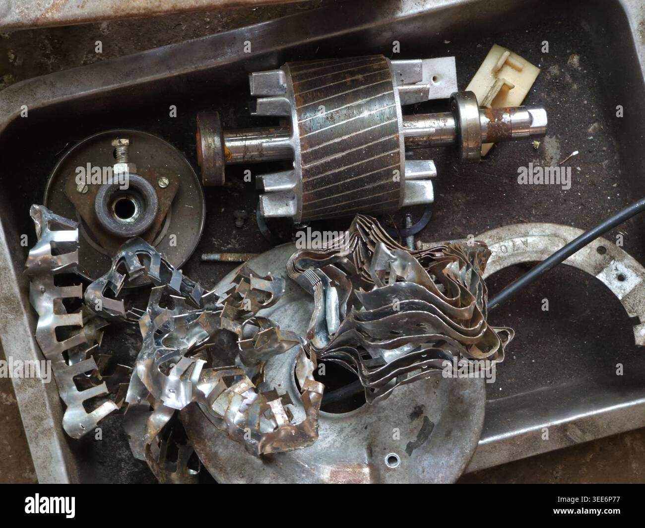 Resting Part Design Broken rusted metal motor part resting in tray displaying chaotic ...